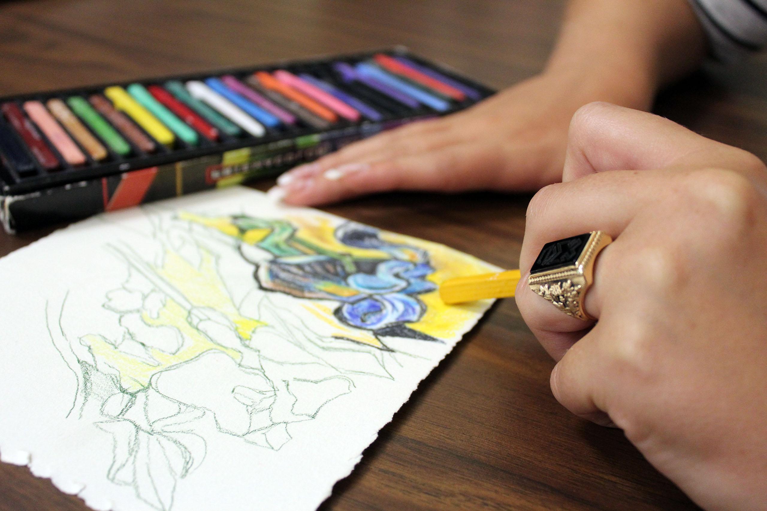 Art therapy student coloring with pastels