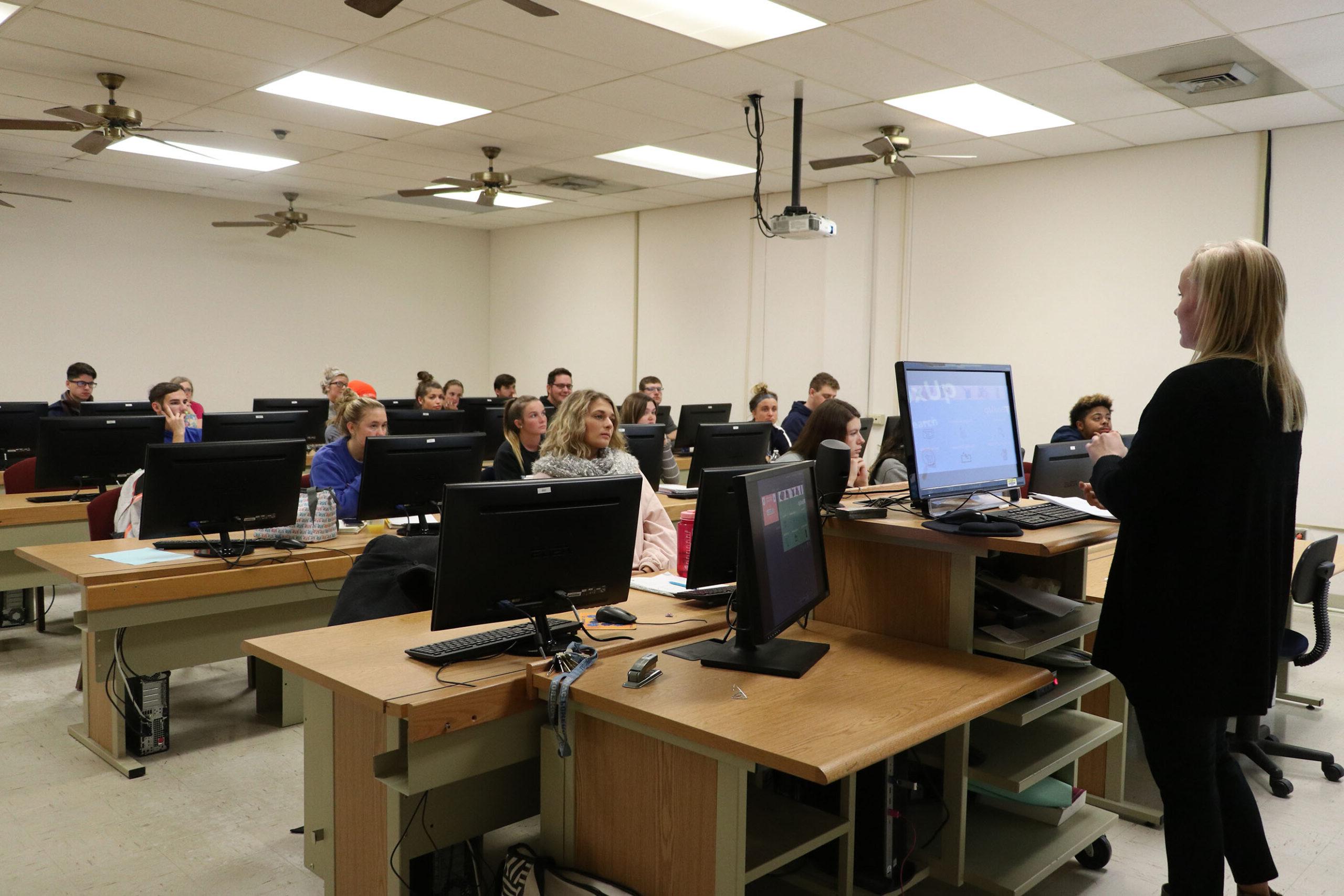 Instructor teaching class of students in computer lab